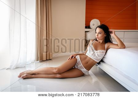 Beautiful young girl in a sexy white lingerie