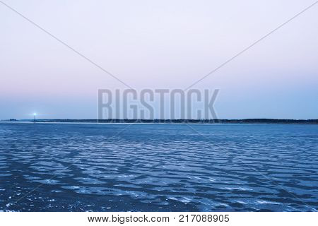 Frozen sea the lighthouse evening sky romantic