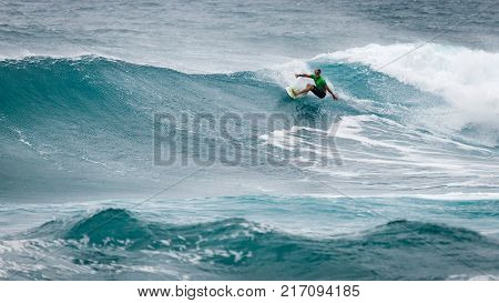 SUNSET BEACH HAWAII USA - DECEMBER 2, 2017: Competitive surfer at the 2017 Vans World Cup of Surfing competition at Sunset Beach on Oahu's scenic North Shore. This is the second of three surfing competitions and Conner Coffin.