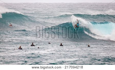 SUNSET BEACH HAWAII USA - DECEMBER 2: Competitive surfers at the 2017 Vans World Cup of Surfing competition at Sunset Beach on Oahu's scenic North Shore. This is the second of three surfing competitions and Conner Coffin