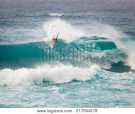 SUNSET BEACH HAWAII USA - DECEMBER 2, 2017: Competitive surfer at the 2017 Vans World Cup of Surfing competition at Sunset Beach on Oahu's scenic North Shore. This is the second of three surfing competitions and Conner Coffin took first place.