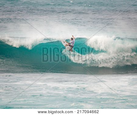 SUNSET BEACH HAWAII USA - DECEMBER 2, 2017: Competitive surfer at the 2017 Vans World Cup of Surfing competition at Sunset Beach on Oahu's scenic North Shore. This is the second of three surfing competitions and Conner Coffin took first place.