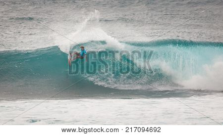 SUNSET BEACH HAWAII USA - DECEMBER 2, 2017: Competitive surfers walking on beach at the 2017 Vans World Cup of Surfing competition at Sunset Beach on Oahu's scenic North Shore. This is the second of three surfing competitions and Conner Coffin took first 
