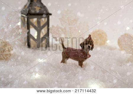 New Year card with toy dog in a fairy forest on winter background with snow and lights. Template greeting card