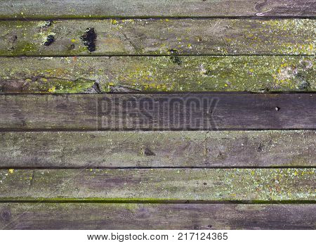 Abstract background of old worn wooden boards of different colors close up