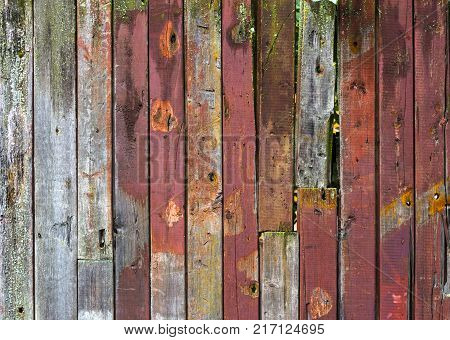Abstract background of old worn wooden boards of different colors close up