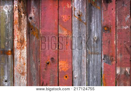 Abstract background of old worn wooden boards of different colors close up