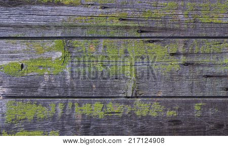 Abstract background of old worn wooden boards of different colors close up