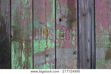 Abstract background of old worn wooden boards of different colors close up