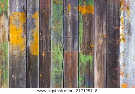 Abstract background of old worn wooden boards of different colors close up