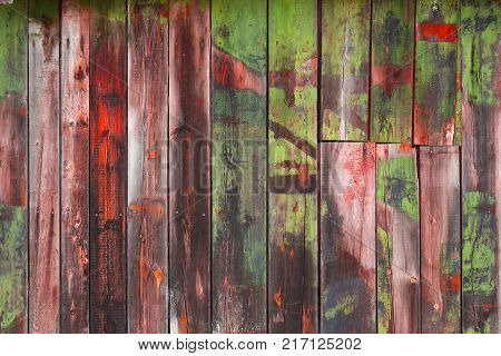 Abstract background of old worn wooden boards of different colors close up