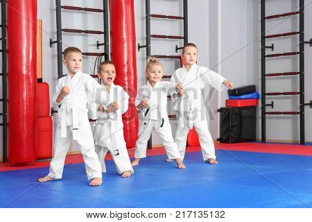 Little children practicing karate in dojo