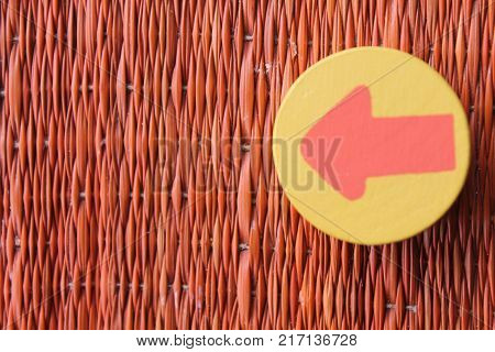 Traditional thai style nature background of brown handicraft weave texture wicker surface for furniture material with red arrow in yellow circle