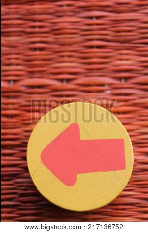Traditional thai style nature background of brown handicraft weave texture wicker surface for furniture material with red arrow in yellow circle