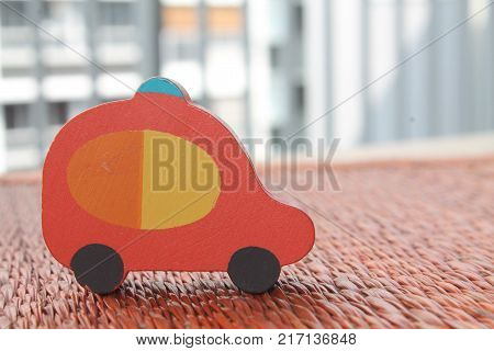 Traditional thai style nature background of brown handicraft weave texture wicker surface for furniture material with red toy car on it