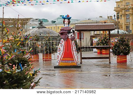 Moscow Russia - February 27 2017: Traditional Dymkovo toy woman with dog as art object at Russian national festival "Shrove" on Manezhnaya square in Moscow