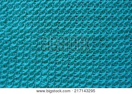 Closeup of handmade turquoise knitwork from above