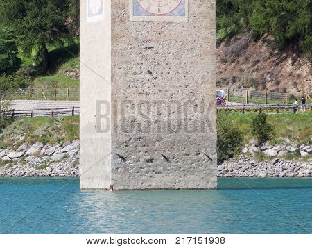 Submerged Tower Of Reschensee Church, Man Swimming Next To It