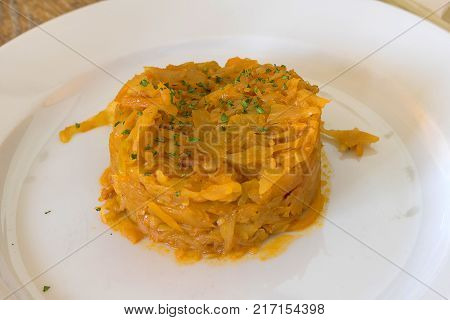 Bigus on a white plate is served in the restaurant as a snack for beer, done in a rustic style