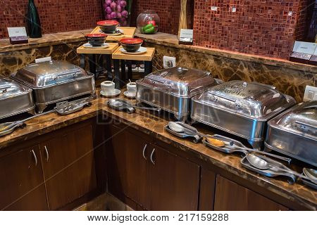 Close up metal containers with prepared dishes for buffet breakfast in hotel