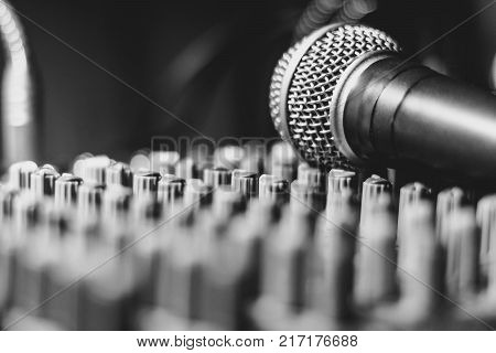 the microphone rests on an audio mixer