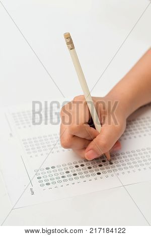woman's hands filling in standardized test form