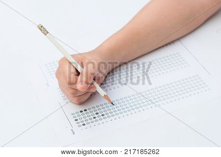 woman's hands filling in standardized test form