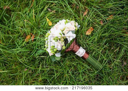 beautiful wedding flowers bouquet on the green grass.