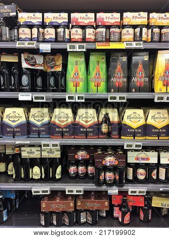 Waterloo, Belgium - November 28, 2017: Belgian beer on the shelf. Six-packs of specialty Belgian beer brands Affligem, Corsendonk, Maredsous and others on the grocery store shelf.