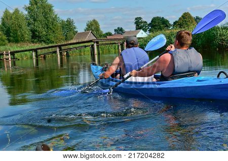 the fusion of two rowers the two rowers in the blue kayak the rowers in the kayak