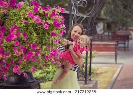 Picture Of Young Lady Brunette Mother In Soft Zebra Shirt And Ivory Colour Skirt Happy Playing With 