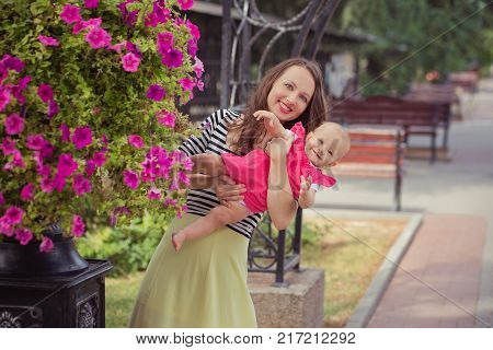 Picture Of Young Lady Brunette Mother In Soft Zebra Shirt And Ivory Colour Skirt Happy Playing With 