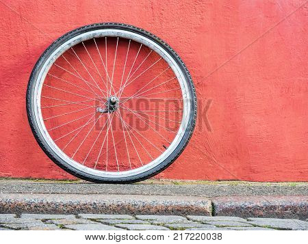 bike wheel on a wall texture sidewalk