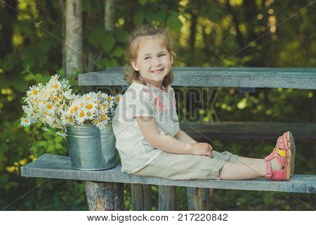 Cute Blond Young Girl Child Stylish Dressed In White Shirt And Short Pants Sitting On Wooden Bench P