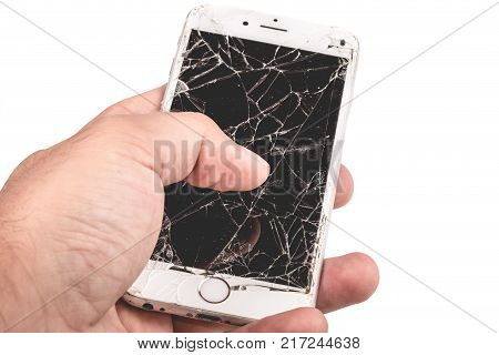 Paris FRANCE - August 26 2017: A man holds in his hand an iphone 6S of Apple Inc. whose screen is broken as a result of a violent fall