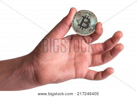 Coin crypto currency bitcoin in the hand of a teenager. Isolated.