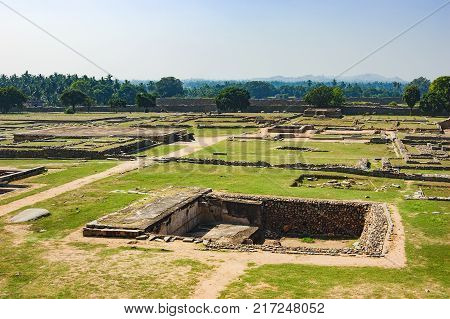 View of ancient stepwell from the platform of Mahanavami Dibba in Hampi, Karnataka, India. Stepwells were developed to cope with seasonal fluctuations in water availability.
