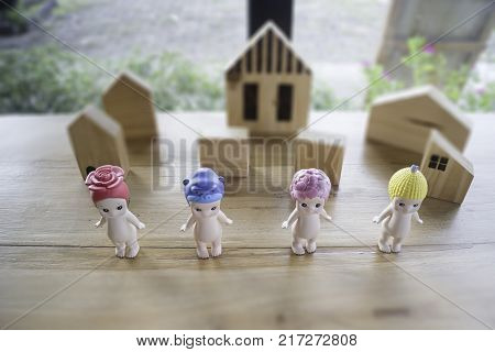 Group of baby naked doll on wooden table stock photo