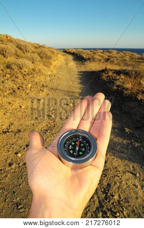 Orientation Concept a Male Hand Holding a Metal Compass