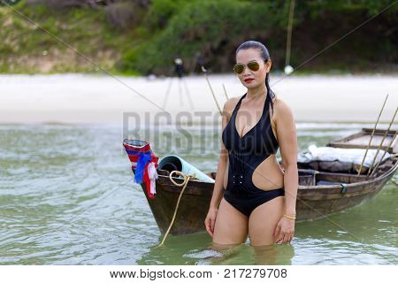 Woman shape sex symbol black bikini and boat on beach at Ban Krut Beach Prachuap Khirikhan Province Thailand