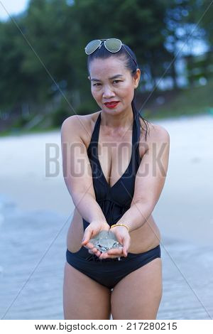 Woman black bikini show shape sexy relax on beach at Ban Krut Beach Prachuap Khirikhan Province Thailand