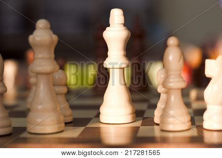 White chess quenn stands out against the background on a chess board