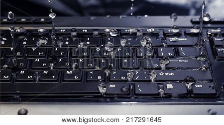water dripping from the keyboard upwards close-up
