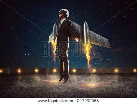 Businessman wear a rocket suit to lift Business success concept .