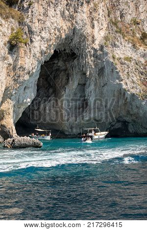 CAPRI ITALY - JUNE 13 2017: Boats with tourists near Grotta Bianca and Grotta Meravigliosa Capri Italy