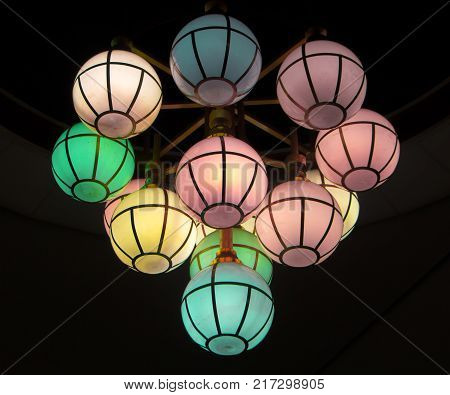 The street lamp in the form of bunches of different colors of round form.