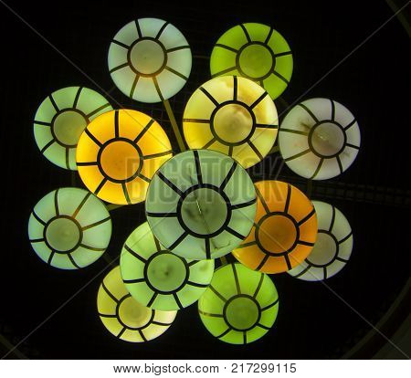 The street lamp in the form of bunches of different colors of round form.