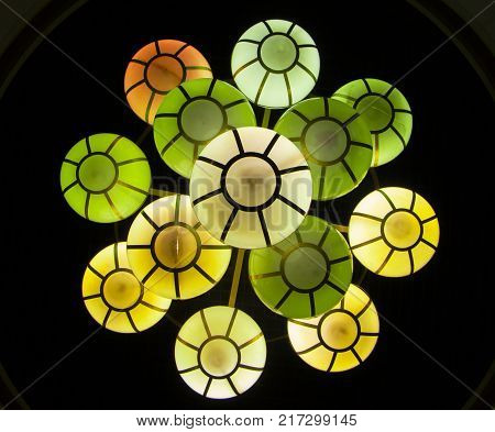 The street lamp in the form of bunches of different colors of round form.