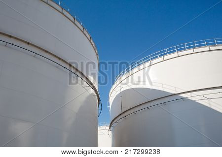Oil tanks under a blue sky at an refinery in Belgium.