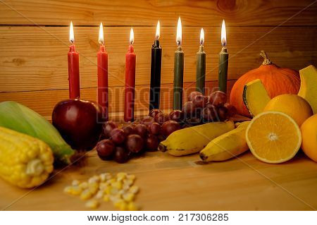 Kwanzaa Holiday Concept With Decorate Seven Candles Red, Black And Green, Gift Box, Pumpkin,corn And
